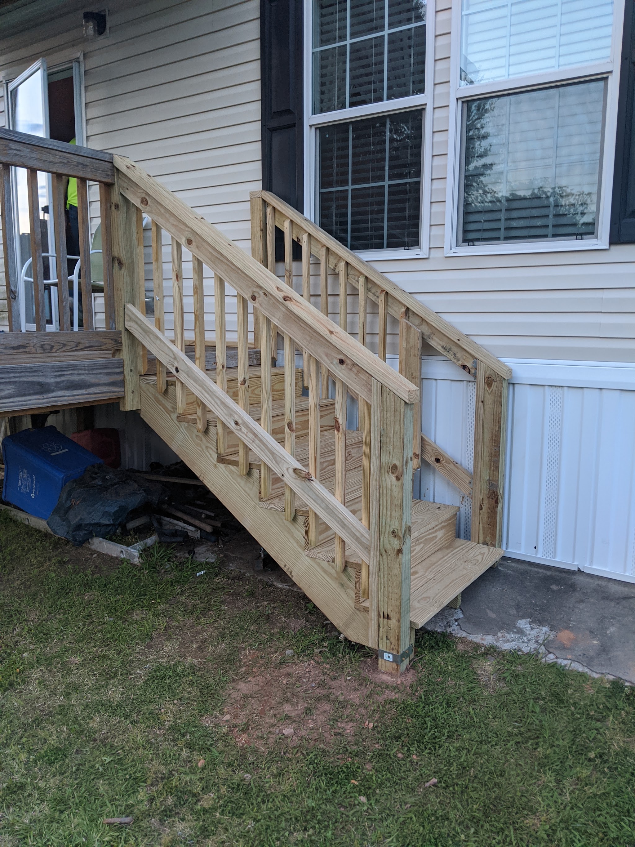 Wooden stairs and landing beside a house